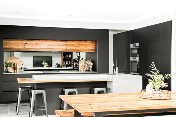 modern black themed kitchen and wooden table